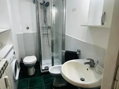 a bathroom with a toilet and a sink and a shower at Little Colosseum Gem in Rome