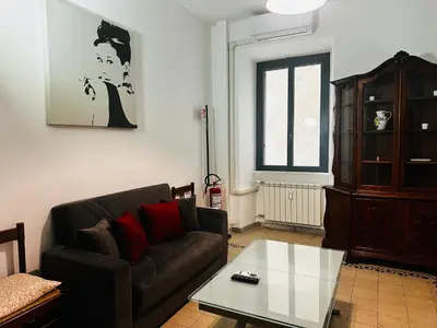 a living room with a couch and a coffee table at Little Colosseum Gem in Rome