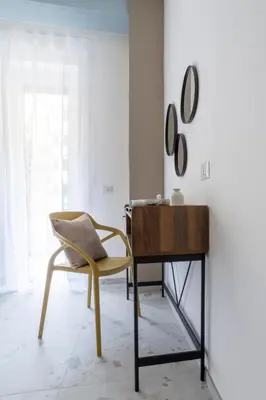 a chair and a desk in a room at Vacanze romane - Domus chic Trastevere - Marconi by Hôtea in Rome