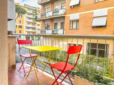 a balcony with three chairs and a yellow table at King Vatican Suite in Rome