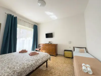 a bedroom with two beds and a window at King Vatican Suite in Rome