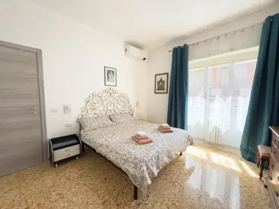 a bedroom with a bed and a large window at King Vatican Suite in Rome