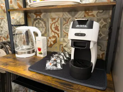 a white mixer sitting on a counter next to a cutting board at King Vatican Suite in Rome