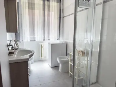 a white bathroom with a toilet and a sink at King Vatican Suite in Rome