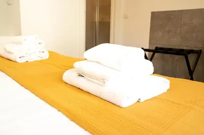 a pile of towels sitting on top of a bed at Salotto Tuscolano in Rome