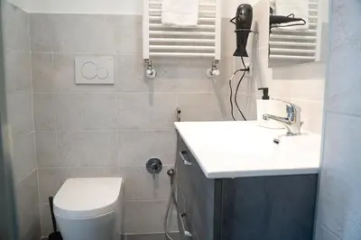 a bathroom with a white sink and a toilet at Salotto Tuscolano in Rome