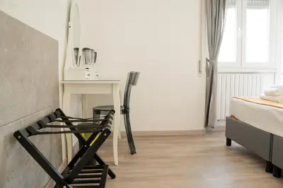 a room with a desk and a chair next to a bed at Salotto Tuscolano in Rome