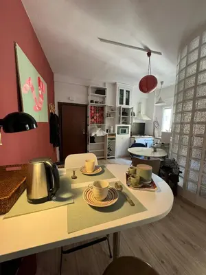 a kitchen and living room with a table with dishes on it at Appartamento Corso Trieste in Rome