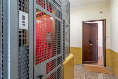a room with a door and a gate with red glass at AureaLiving - Satrico Cozy Apartment fast WIFI and Air Conditioning in Rome