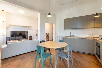 a kitchen and dining room with a table and chairs at AureaLiving - Satrico Cozy Apartment fast WIFI and Air Conditioning in Rome