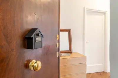 a wooden door with a mailbox on it at AureaLiving - Satrico Cozy Apartment fast WIFI and Air Conditioning in Rome