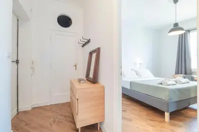 a white bedroom with a bed and a mirror at AureaLiving - Satrico Cozy Apartment fast WIFI and Air Conditioning in Rome