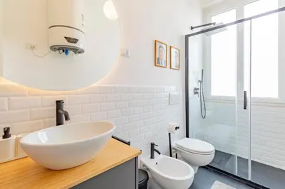 a bathroom with a sink and a toilet at AureaLiving - Satrico Cozy Apartment fast WIFI and Air Conditioning in Rome