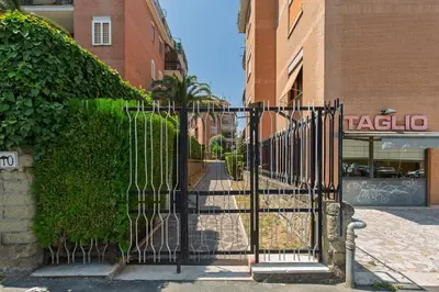 a black gate in front of a building at La Buganvillea locazione turistica in Rome