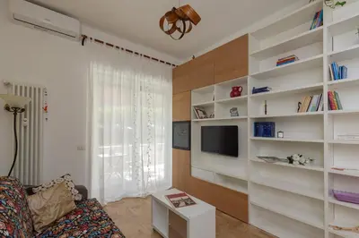 a living room with white shelves and a tv at La Buganvillea locazione turistica in Rome