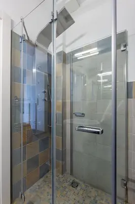 a shower stall with a glass door in a bathroom at La Buganvillea locazione turistica in Rome