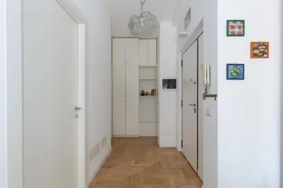a hallway with white walls and a wooden floor at La Buganvillea locazione turistica in Rome