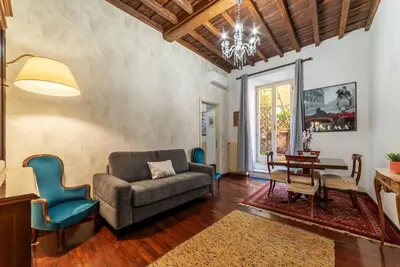 a living room with a couch and a table and chairs at Trevi Garden Suite in Rome