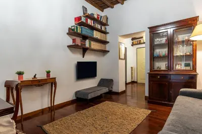 a living room with a couch and a tv at Trevi Garden Suite in Rome