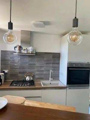 a kitchen with a sink and a stove at Chic Penthouse Retreat in Rome