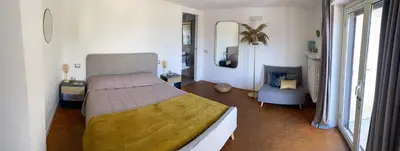 a bedroom with a bed and a chair in it at Chic Penthouse Retreat in Rome