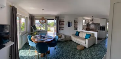 a living room with a table and a couch at Chic Penthouse Retreat in Rome