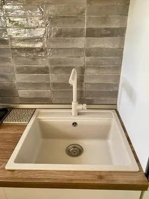 a kitchen sink with a faucet on top of it at Chic Penthouse Retreat in Rome