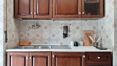a kitchen with wooden cabinets and a sink at Appartamento via Caneva - Tiburtina in Rome