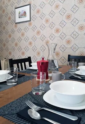 a table with a white plate on top of it at Appartamento via Caneva - Tiburtina in Rome