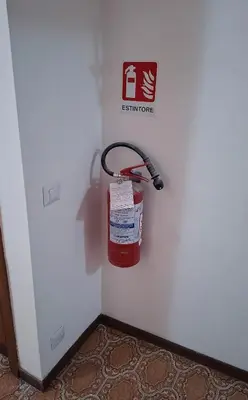 a fire extinguisher hanging on the side of a wall at Appartamento via Caneva - Tiburtina in Rome