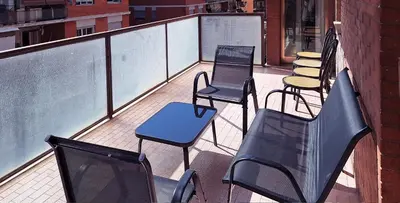 a group of chairs and tables on a balcony at Appartamento via Caneva - Tiburtina in Rome