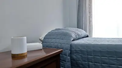 a bed in a bedroom with a table and a window at Appartamento via Caneva - Tiburtina in Rome