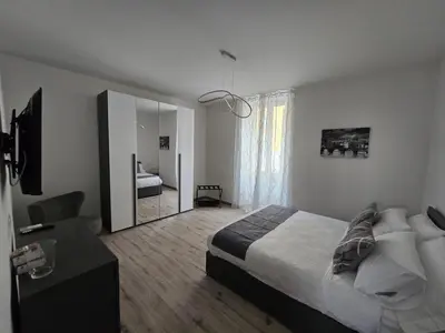 a bedroom with a large bed and a mirror at Di Lollo Comfort Suites in Rome