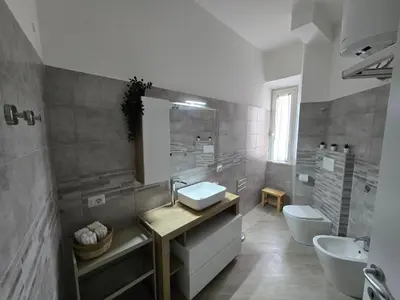 a bathroom with a sink and a toilet at Di Lollo Comfort Suites in Rome