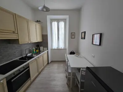 a kitchen with a sink and a table in it at Di Lollo Comfort Suites in Rome