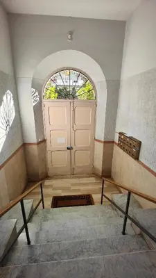 a hallway with stairs and a wooden door with a staircase at Residence Il Vittoriano in Rome