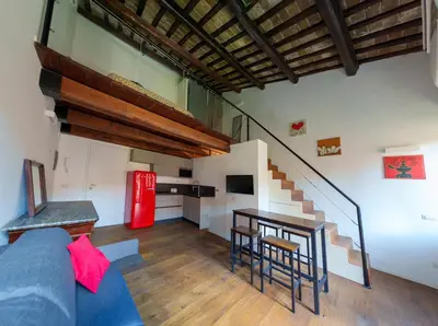 a living room with a blue couch and a red refrigerator at Le Lune Apartment in Rome
