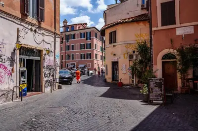 a woman walking down a street in an alley at Le Lune Apartment in Rome