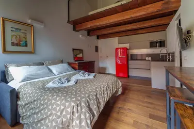 a bedroom with a bed and a red refrigerator at Le Lune Apartment in Rome