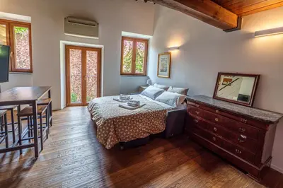 a bedroom with a bed and a table and a desk at Le Lune Apartment in Rome