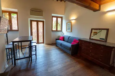 a living room with a blue couch and a table at Le Lune Apartment in Rome