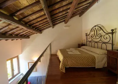 a bedroom with a bed in a room with wooden ceilings at Le Lune Apartment in Rome