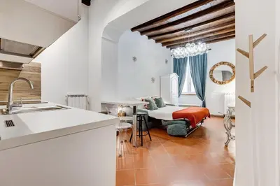 a kitchen with a sink and a table at New Spanish Square - RomeDreamHome in Rome