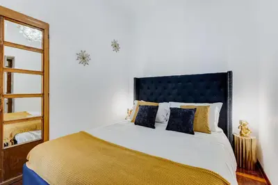 a bedroom with a large bed and a mirror at New Spanish Square - RomeDreamHome in Rome