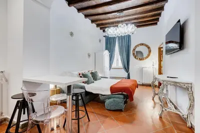 a bedroom with a bed and a table and chairs at New Spanish Square - RomeDreamHome in Rome