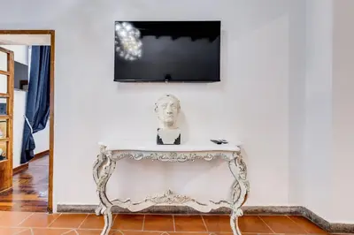 a bust of a man sitting on a table in a room at New Spanish Square - RomeDreamHome in Rome