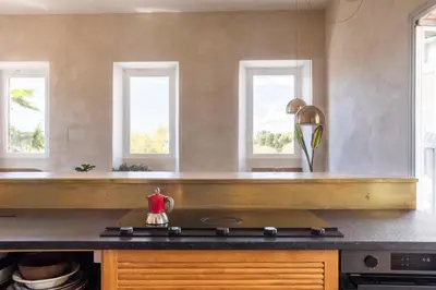 a kitchen with two windows and a stove top oven at Labicasa in Rome