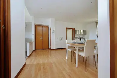 a kitchen and dining room with a table and chairs at Stazione Trastevere 3BR Flat by Flatinrome in Rome