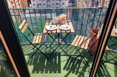 a balcony with a table and chairs on a balcony at Stazione Trastevere 3BR Flat by Flatinrome in Rome