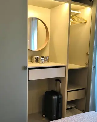 a closet with a mirror and a suitcase in it at CEMMA luxury apartment in Rome